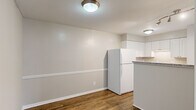 Located at 903 Kensington Ct in Cary, NC, this single-floor, 2-bedroom, 2-bathroom home offers a practical and well-appointed layout. Rich wood-look flooring runs throughout the main living areas, complemented by neutral gray walls and clean white trim that create a cohesive, modern aesthetic.

The kitchen is a functional highlight, featuring white shaker-style cabinetry, granite countertops, a peninsula with breakfast bar seating, and a suite of white appliances. It opens conveniently toward the living and dining area, making the space feel connected and efficient.

The living area is bright and airy, anchored by sliding glass doors that open to a private outdoor deck, offering views of the surrounding neighborhood and greenery — a standout feature of the home.

Both bedrooms are carpeted for comfort and include closets for storage. The primary bedroom is generously sized with access to its own dedicated space, while the secondary bedroom features a window with natural light and a sliding closet. Each bedroom benefits from its own bathroom: one includes a tub-shower combination with white tile surround, while the other is neatly appointed with a vanity and toilet.

The entrance and hallway provide smooth transitions between rooms, completing a thoughtfully organized floor plan suited for comfortable everyday living.