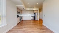 Located at 5880 W Alameda Ave in Lakewood, Colorado, this single-floor residence offers three bedrooms and two bathrooms within a thoughtfully arranged floor plan. The interior is finished with warm wood-look luxury flooring that flows consistently throughout every room, complemented by crisp white walls and clean white baseboard trim that give the space a fresh, modern feel.

The kitchen is a standout feature, showcasing light wood cabinetry, a white subway tile backsplash, stainless steel appliances including a refrigerator, range, microwave, and dishwasher, as well as recessed and track lighting above. It opens directly to the living area, creating a seamless and functional layout.

The primary bedroom is a comfortable, well-proportioned room featuring large windows with vertical blinds that allow ample natural light and outdoor views. The additional bedrooms are bright and similarly finished, with windows overlooking the surrounding greenery. Several bedrooms include closets for practical storage.

Both bathrooms continue the clean, contemporary aesthetic. One features a full tub-shower combination with white tile surround and brushed nickel fixtures, while the second is a practical half bath. A connecting hallway ties all rooms together efficiently. The overall ambiance is clean, light-filled, and move-in ready.