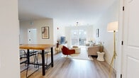 Located at 87 Union St in New Haven, CT, this well-appointed residence offers four bedrooms and four bathrooms across a thoughtfully designed single-floor layout. The open-concept kitchen and living area serves as the heart of the home, featuring crisp white cabinetry, stainless steel appliances, a butcher block island with seating, and light hardwood-style flooring that flows seamlessly throughout. The living room is bright and airy, with large sliding glass doors opening onto a private balcony that brings in generous natural light and outdoor views of the surrounding neighborhood. Each of the four bedrooms is comfortably sized, with large windows offering urban views, neutral tones, and hardwood-style flooring that lend a clean, modern feel. The primary bedroom provides a spacious and serene retreat. All four bathrooms are consistently finished with white shaker-style cabinetry, gray quartz countertops, undermount sinks, matte black fixtures, and tiled tub-shower combinations, delivering a cohesive and polished aesthetic. A central hallway connects the living spaces efficiently, while the overall design emphasizes clean lines, contemporary finishes, and a bright, welcoming ambiance throughout the entire residence.