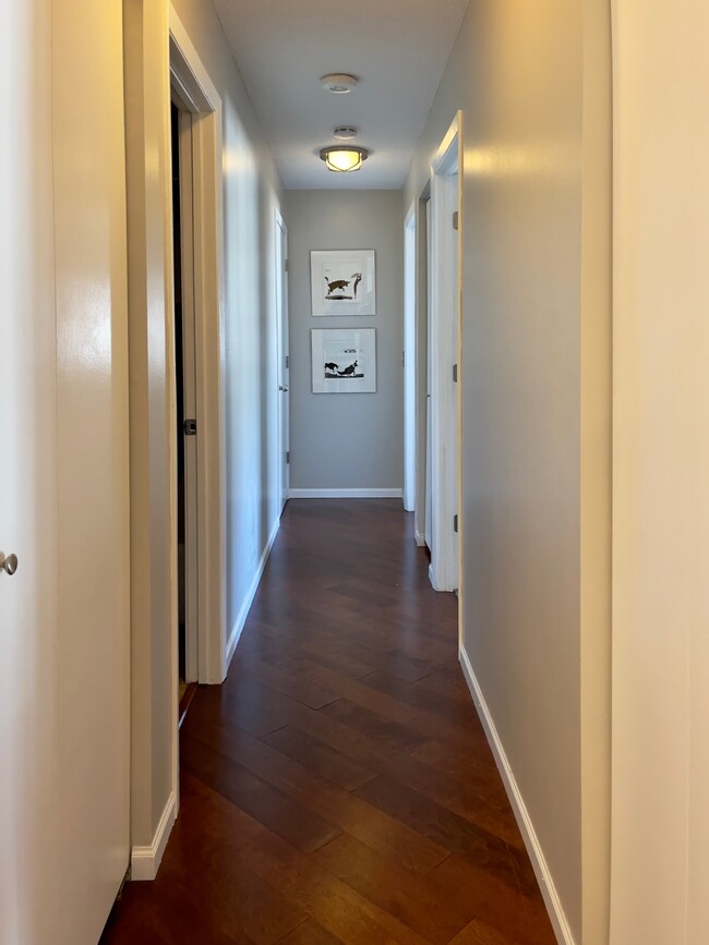 Hallway leads to 2 bedrooms, 2 bathrooms, and laundry space. - 2262 Benson Ave