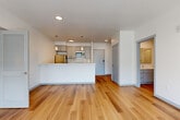 Located at 2707 E 6th St in Vancouver, WA, this modern 3-bedroom, 2-bathroom unit offers a thoughtfully designed single-floor layout. The open-concept living and kitchen area is anchored by a peninsula with white quartz countertops, gray shaker-style cabinetry, subway tile backsplash, and stainless steel appliances including a built-in microwave and dishwasher. Pendant lighting and recessed fixtures illuminate the space, which flows seamlessly into the living area, where warm hardwood-style flooring and large sliding glass doors invite abundant natural light and provide access to a private balcony with exterior views. An in-unit stacked washer and dryer adds everyday convenience. The primary bedroom features balcony access, a wall-mounted mini-split HVAC unit, and an en-suite bathroom with a walk-in closet equipped with built-in shelving. Both bathrooms are finished with gray vanity cabinetry, white countertops, and clean tile surrounds. The additional bedrooms are carpeted, bright, and include closet storage. Throughout, a neutral color palette, modern hardware, and consistent finishes create a clean, contemporary ambiance well-suited for comfortable living.