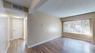 This efficiently designed 1-bedroom, 1-bathroom unit offers a thoughtful layout across a single floor, making excellent use of every square foot. The living room is bright and welcoming, featuring warm-toned walls, wood-style laminate flooring, a textured ceiling, and a large window with vertical blinds that invites natural light and offers views of surrounding greenery. A ceiling fan in the adjacent dining area adds both function and comfort to the open flow between the living and dining spaces.

The galley-style kitchen is well-appointed with light wood cabinetry, dark granite-look countertops, and stainless steel appliances including a refrigerator, electric range, and dishwasher. The parallel counter layout maximizes workspace and storage, making the kitchen highly functional despite its compact form.

The bedroom is a comfortable retreat finished with plush carpeting, warm neutral walls, a textured ceiling, and a window with vertical blinds that allows for natural light. A closeted entryway provides convenient storage, and the room connects easily to the hallway. Two closets throughout the unit offer ample storage solutions. The bathroom and hallway complete the layout, contributing to the unit's practical and cohesive design. Overall, the space presents a clean, move-in-ready interior with consistent warm neutral tones throughout.