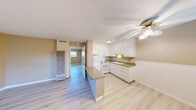 Located at 1221 Vallejo Ave in Novato, California, this one-bedroom, one-bathroom unit offers a well-organized, single-floor layout designed to maximize functionality within a compact footprint. Light wood-style flooring runs throughout the living areas, creating a bright and cohesive aesthetic.

The kitchen is a central feature of the space, equipped with white cabinetry providing ample upper and lower storage, a double-basin sink, a full-size refrigerator, and an electric range with overhead ventilation. A peninsula counter separates the kitchen from the living area, offering additional workspace. A ceiling fan with a light fixture overhead enhances airflow and illumination in this shared zone. Textured ceilings are consistent throughout the unit.

The bedroom is a comfortable, well-proportioned room finished with the same light flooring and warm neutral wall tones. A window allows natural light to fill the space, and a dedicated closet provides convenient storage.

The bathroom features a white vanity with under-sink storage, a countertop sink, a toilet, and a shower area, all finished with light tile flooring and warm-toned walls. A window above the vanity brings in additional natural light, keeping the room bright and airy. The overall color palette of soft beiges and crisp whites gives the unit a clean, move-in-ready appearance.