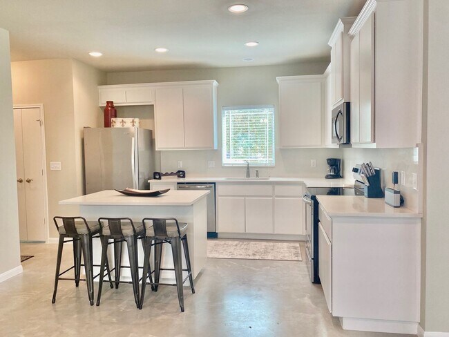 Building Photo - This charming two-story home, built in 2018, offers a spacious open floor plan perfect for casual...