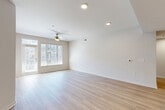 Located at 180 Jackson St NE in Atlanta's vibrant Old Fourth Ward neighborhood, this well-appointed 2-bedroom, 2-bathroom residence offers a thoughtfully designed open-concept floor plan. The spacious living room is bathed in natural light from large windows and a glass door, complemented by light-toned hardwood flooring and a ceiling fan that enhances the airy atmosphere.

The kitchen serves as the heart of the home, featuring a generous island with striking quartz countertops accented by subtle veining, dark charcoal cabinetry, stainless steel appliances, and a classic tile backsplash. Three pendant lights with brushed nickel finishes hang above the island, adding a modern industrial touch.

Both bedrooms are comfortably sized, carpeted for warmth, and equipped with ceiling fans and natural light from double windows. The primary bedroom offers a notably spacious footprint and is paired with a well-designed en-suite bathroom featuring a double-sink vanity, quartz countertops, dark cabinetry, and hardwood-style flooring. The second bathroom mirrors the same refined aesthetic with a single vanity and a shower/tub combination. Two dedicated closets, including a walk-in with built-in shelving, provide ample storage throughout the home.
