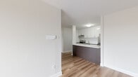 Located at 1111 Rue Mistral in Montréal, this single-floor unit offers a practical and modern layout across three bedrooms and one bathroom. The interior design is clean and contemporary throughout, unified by light hardwood flooring and neutral white walls that create a bright, cohesive atmosphere.

The kitchen is a standout feature, equipped with stainless steel appliances including a range and dishwasher, white upper cabinetry, and dark wood-toned lower cabinets paired with a white countertop. A peninsula with matching dark cabinetry defines the kitchen space and provides additional prep and storage areas. An under-cabinet range hood and a stainless steel sink complete the functional setup.

The three bedrooms maintain the consistent aesthetic of light flooring and neutral walls. Each room includes a sliding-door closet with built-in rods, offering practical storage. The primary bedroom is a comfortable size, and at least one bedroom benefits from a large window with views of the surrounding Montréal neighbourhood.

The bathroom is finished in a clean, minimalist style with white tile flooring, a wall-mounted vanity featuring wood-toned cabinetry and a white countertop, a large mirror, and a separate shower area. A welcoming hallway connects all areas of the unit seamlessly.