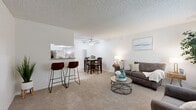 Located on Vanowen Street in Van Nuys, Los Angeles, this single-story unit offers a practical and well-organized layout across one floor. The living area is bright and welcoming, featuring plush carpeting, a ceiling fan, and a large window that lets in generous natural light and views of surrounding greenery. The open-concept design flows seamlessly into the dining area, which is defined by light wood-style flooring. A pass-through window connects the dining space to the kitchen, adding a functional and social element to the layout. The kitchen is clean and efficient, with white cabinetry and ample counter space. The spacious primary bedroom is carpeted and features a mirrored sliding-door closet that enhances the sense of openness, along with a window providing natural light. The unit includes two bathrooms: one featuring a vanity with white cabinetry and a large mirror, and the other a full bath with a shower/tub combination and light wood-style flooring. Throughout the unit, neutral tones and white walls create a clean, versatile backdrop. The textured ceilings are consistent throughout the home, adding a classic residential character to each room.
