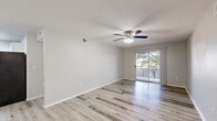 Located at 3500 Foothills Rd in Las Cruces, NM, this thoughtfully designed two-bedroom, two-bathroom single-floor residence offers a clean, modern aesthetic throughout. Light wood-style flooring flows seamlessly across every room, creating a bright and cohesive feel.

The living room is a welcoming, open space featuring a ceiling fan with light kit and a sliding glass door that opens to a private balcony, filling the room with natural light and outdoor views of surrounding trees. The adjacent kitchen and dining area is well-appointed with white shaker cabinetry, dark granite-style countertops, a white subway tile backsplash, a stainless steel double-basin sink, and black appliances including a refrigerator, range, and dishwasher. A skylight-style overhead fixture keeps the space bright.

Both bedrooms are comfortably sized, each featuring ceiling fans, neutral walls, and abundant natural light from windows with blinds. The primary bedroom includes a dedicated closet for added storage.

The two bathrooms echo the kitchen's design language, showcasing dark marble-style countertops atop white vanity cabinetry, large mirrors, and clean white tub-shower combinations with brushed nickel hardware. Multiple hallways connect the layout efficiently, completing this well-organized and attractive Las Cruces residence.