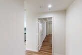 Located on Exchange Street in the heart of Providence, Rhode Island, this 2-bedroom, 2-bathroom residence offers a well-organized, single-floor layout designed for comfortable everyday living. Light hardwood-style flooring runs consistently throughout the space, creating a warm, cohesive aesthetic from room to room.

The open living area is a standout feature, bathed in natural light through large windows and offering direct access to a private balcony with outdoor views of the surrounding cityscape. The space is generous and well-proportioned, accommodating both a living and dining area with ease.

The kitchen is efficiently designed, featuring white cabinetry, stainless steel appliances, and clean finishes. A dedicated hallway connects the private areas of the residence, lined with six closets that provide exceptional storage capacity — a notable practical advantage.

Both bedrooms are bright and comfortable, each receiving natural light through well-placed windows. The primary bedroom is spaciously sized and includes a large bi-fold closet. Both bathrooms are identically appointed with full tub-shower combinations, white vanity cabinetry, gray countertops, framed mirrors, and hardwood-style flooring, maintaining a consistent, clean aesthetic. Recessed lighting and classic six-panel doors complete the polished, functional character of this Providence residence.