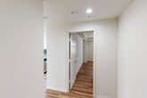 Located on Exchange Street in the heart of Providence, Rhode Island, this 2-bedroom, 2-bathroom residence offers a well-organized, single-floor layout designed for comfortable everyday living. Light hardwood-style flooring runs consistently throughout the space, creating a warm, cohesive aesthetic from room to room.

The open living area is a standout feature, bathed in natural light through large windows and offering direct access to a private balcony with outdoor views of the surrounding cityscape. The space is generous and well-proportioned, accommodating both a living and dining area with ease.

The kitchen is efficiently designed, featuring white cabinetry, stainless steel appliances, and clean finishes. A dedicated hallway connects the private areas of the residence, lined with six closets that provide exceptional storage capacity — a notable practical advantage.

Both bedrooms are bright and comfortable, each receiving natural light through well-placed windows. The primary bedroom is spaciously sized and includes a large bi-fold closet. Both bathrooms are identically appointed with full tub-shower combinations, white vanity cabinetry, gray countertops, framed mirrors, and hardwood-style flooring, maintaining a consistent, clean aesthetic. Recessed lighting and classic six-panel doors complete the polished, functional character of this Providence residence.