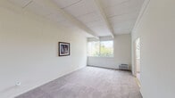 Located at 6920 Sepulveda Blvd in Los Angeles, CA, this single-story residence offers a clean, bright interior with a cohesive neutral palette throughout. The living area is a standout feature, showcasing distinctive exposed beam ceilings that add architectural character and a sense of openness. Soft carpeting, crisp white walls, and a large picture window that frames lush greenery outside create a calm, airy atmosphere filled with natural light. The kitchen is well-equipped and functional, featuring white cabinetry with ample storage, light wood-look flooring, a gas range, a stainless steel refrigerator, and a window dressed with vertical blinds that invite additional natural light and garden views. The bedroom is generously proportioned, continuing the exposed beam ceiling design, and includes mirrored sliding closet doors that enhance the sense of space, along with a built-in closet organizer for added storage convenience. The bathroom offers an L-shaped vanity with white cabinetry, a broad mirror, and efficient use of space, complemented by light wood-look flooring that ties the interior together. Overall, this residence presents a practical and comfortable layout with consistent design elements, making it a welcoming space in the Van Nuys neighborhood of Los Angeles.