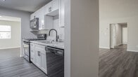 This single-floor residence on Pinewood Drive in Yorktown, Virginia offers a clean, updated interior designed for comfortable everyday living. The open living area is among the most notable spaces, featuring wood-style plank flooring and a large sliding glass door that fills the room with natural light while providing outdoor access. An adjacent area with matching flooring connects seamlessly to the rest of the home, creating a functional flow throughout.

The kitchen is well-appointed with white shaker-style cabinetry, granite-look countertops, a stainless steel sink with a matte black faucet, and black appliances including a gas range with oven and an over-the-range microwave. The neutral palette and modern hardware give the kitchen a fresh, contemporary feel.

The bedrooms are carpeted and generously sized, with windows that bring in natural light. At least one bedroom features dual closets, providing ample storage. The primary bedroom includes an en-suite bathroom and walk-in closet access. The bathroom is finished with a white vanity, solid-surface countertop, and matte black fixtures with a large mirror above.

A dedicated laundry area is visible within the floor plan. Throughout the home, neutral gray-beige wall tones, clean white trim, and consistent finishes contribute to a cohesive, move-in-ready aesthetic.