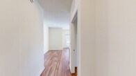 Located at 7800 Creekridge Road in Charlotte, NC, this single-story, 3-bedroom, 2-bathroom home offers a well-organized and accessible layout across a comfortable footprint. Warm hardwood-style flooring flows throughout every room, complementing the clean, bright white walls and creating a cohesive, modern aesthetic.

The open-concept living, dining, and kitchen area serves as the heart of the home. The kitchen is well-appointed with light maple cabinetry, granite countertops, stainless steel appliances including a refrigerator and range, a center island with additional counter space, and track lighting overhead. Large windows allow abundant natural light to fill the space.

The three bedrooms are bright and airy, each featuring large windows that invite natural light, ceiling fans, and generous closet access — with five closets distributed throughout the home. The primary bedroom offers a comfortable and private retreat.

Both bathrooms are designed with accessibility in mind, featuring grab bars, open floor space, hardwood-style flooring, and vanities with granite countertops. A dedicated laundry area and a central hallway add to the home's practical layout. The property also includes on-site parking with landscaped surroundings.