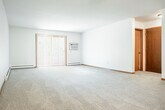 Located at 72 Kessel Ct in Madison, WI, this single-floor, 2-bedroom, 2-bathroom residence offers a well-organized and functional layout. The open kitchen and living room area serves as the heart of the home, featuring warm oak cabinetry with ample upper and lower storage, light-toned countertops, wood-look flooring, and black appliances including a range and dishwasher. The spacious living room is filled with natural light through a large sliding glass door fitted with vertical blinds, which opens to a brick-edged patio overlooking a lush, tree-lined green space. Both bedrooms are carpeted for comfort; the generously sized primary bedroom includes a ceiling fan with light fixture, a baseboard heating unit, and a window with outdoor views. The two bathrooms are finished with wood-toned vanities and wood-look tile flooring, with one featuring a full tub-shower combination. A dedicated in-unit laundry area accommodates a full-size washer and dryer with overhead shelving. Four closets provide exceptional storage throughout. Two hallways connect the rooms efficiently, and a welcoming entrance completes the layout. Warm wood trim accents and neutral tones create a cohesive, comfortable ambiance throughout.