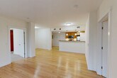 Located in Cambridge, MA, this two-bedroom, two-bathroom residence offers a thoughtfully designed single-floor layout that includes a study, pantry, and in-unit laundry. The open-concept living and dining area is generously proportioned, featuring gleaming light hardwood floors and large windows that frame views of the surrounding greenery, filling the space with natural light.

The kitchen is a functional highlight, outfitted with warm maple cabinetry, granite countertops, stainless steel appliances—including a refrigerator, electric range, built-in microwave, and dishwasher—and a peninsula that connects seamlessly to the living area. Pendant lighting above the peninsula adds a refined touch, while tile flooring grounds the space.

Both bedrooms are carpeted and well-sized, with the primary bedroom featuring built-in closets with rich wood-toned doors and direct access to a private bathroom. The second bedroom offers natural light through a pair of windows with outdoor views. The primary bathroom includes a tub/shower combo and a warm wood vanity, while the second bathroom is equipped with a pedestal sink and a walk-in shower with brushed nickel fixtures. The in-unit laundry and pantry add everyday convenience to this well-appointed Cambridge residence.
