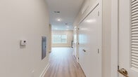 Located at 405 South 4th Street in Nashville's vibrant East Side neighborhood, this efficiently designed single-floor unit offers a bright, modern living experience. The open-concept layout maximizes every inch of the space, with light-toned luxury vinyl plank flooring running throughout and recessed lighting providing consistent, even illumination.

The kitchen is a standout feature, outfitted with white shaker-style cabinetry, granite countertops, and a full suite of stainless steel appliances including a refrigerator, range, microwave, and dishwasher. A large window floods the kitchen and main living area with natural light, enhancing the clean, airy aesthetic. The open layout allows the kitchen and living area to flow seamlessly together.

A wide hallway connects the main living space to the rest of the unit, featuring a built-in mail slot and a large white paneled closet door, providing practical storage solutions. The bathroom continues the modern design language with granite countertops on the vanity, a walk-in shower with a built-in bench seat, and chrome fixtures throughout. White walls and wood-look flooring keep the bathroom feeling bright and cohesive with the rest of the unit. Overall, the space presents a clean, move-in-ready environment with contemporary finishes throughout.
