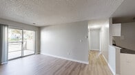 Located at 14304 E Tennessee Ave in Aurora, CO, this 2-bedroom, 2-bathroom residence offers a well-organized single-floor layout designed for comfortable everyday living. The open living room serves as the heart of the home, highlighted by a classic fireplace with a sleek dark tile surround and warm hardwood-style flooring. A sliding glass door floods the space with natural light and opens directly onto a private balcony, providing a pleasant outdoor extension of the living area.

The kitchen is efficiently laid out with white cabinetry, dark granite-style countertops, stainless steel appliances including a refrigerator and range, and a built-in sink. Hardwood-style flooring continues seamlessly from the living area into the kitchen, creating a cohesive feel throughout the main living spaces.

Both bedrooms are comfortably sized, featuring the same warm flooring, neutral gray tones, textured ceilings, and windows with blinds that allow for natural light and privacy. The primary bedroom includes a sliding-door closet, while the second bedroom also offers ample closet space. The two bathrooms are clean and functional — one features a glass-enclosed walk-in shower, while the other offers a full tub-shower combination with updated chrome fixtures. A utility room completes the layout, adding practical storage and mechanical access.