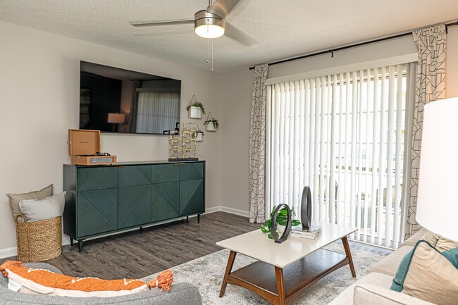 Spacious living room with hardwood-style flooring - The Alexander Apartment Homes