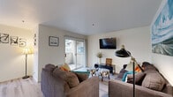 Located at 2505 5th St in Davis, CA, this 2-bedroom, 2-bathroom residence offers a well-organized single-floor layout designed for comfortable everyday living. The living room features light wood-style flooring, a sliding glass door opening to a private balcony with outdoor views, and a bright, open atmosphere. Adjacent to the living area, the combined dining room and kitchen create a functional, connected space. The kitchen is outfitted with white cabinetry, a skylight panel for added brightness, and black appliances including a refrigerator, range, microwave, and dishwasher. The dining area benefits from large windows overlooking a pool area, with a ceiling fan adding comfort. The primary bedroom is carpeted, ceiling fan-equipped, and filled with natural light from multiple windows. The second bedroom also features carpet and a large window, comfortably accommodating two beds. Both bathrooms are clean and practical, with one featuring a dual-sink vanity with stone-patterned countertops and wood-style flooring. A dedicated in-unit laundry closet houses a full-size washer and dryer with shelving above. Hallways connect each space efficiently, completing this thoughtfully arranged home.