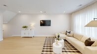 This well-appointed 2-bedroom, 3-bathroom residence in Toms River, NJ spans three floors, offering a thoughtfully designed layout with modern finishes throughout. Light hardwood flooring and a clean, neutral color palette create a cohesive and airy atmosphere across every level.

The main living floor features an open kitchen and living room combination. The kitchen is outfitted with sleek flat-front cabinetry in a warm wood tone, stainless steel appliances including a gas range and refrigerator, white quartz countertops, and a modern pendant light fixture. The adjacent living area is bright and inviting, with recessed lighting, sheer drapery allowing ample natural light, and a comfortable, open arrangement.

The upper floor is dedicated to the bedrooms. The generously sized primary bedroom offers a serene retreat with sheer floor-to-ceiling curtains, light hardwood floors, and access to a private bathroom. The second bedroom is equally bright, benefiting from multiple windows with natural light and ample space. Three full bathrooms are distributed across the home, each finished with contemporary floating vanities, wood-toned cabinetry, white countertops, and light tile flooring. Staircases connect all three levels, complemented by hallways that maintain the home's clean, modern aesthetic.