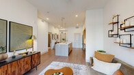 Located at 3421 N Freeway Blvd in Sacramento, CA, this thoughtfully designed one-bedroom, one-bathroom residence offers a modern open-concept layout across a single floor. Light wood-tone flooring flows throughout, complementing the crisp white walls and recessed lighting that keep the space bright and cohesive.

The kitchen serves as the centerpiece of the home, featuring a large island with a white quartz countertop, pendant lighting, light wood cabinetry extending to the ceiling, and a full suite of stainless steel appliances. The open design connects seamlessly to the living room, which is bathed in natural light from sliding glass doors that open to a private balcony.

The bedroom is a comfortable retreat with large windows framing outdoor views, high ceilings, and wood flooring. Two closets provide ample storage, and a dedicated in-unit laundry area adds everyday convenience.

The bathroom features a full soaking tub with tiled surround, clean white walls, and wood-finish flooring, offering a calm and functional space. Throughout the residence, the design balances modern minimalism with warm materials, creating an inviting and well-appointed living environment.