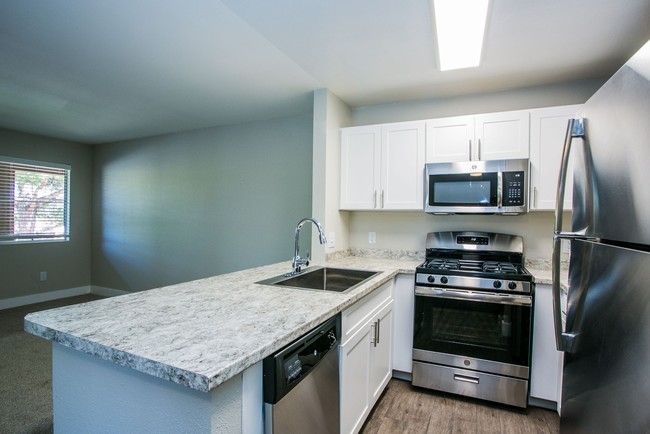 Granite breakfast bar overlooking living area. - The Lido Apartments