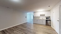 Located at 2136 West Riverside Avenue in Spokane, Washington, Unit 412 is a thoughtfully designed single-floor residence featuring contemporary updates throughout. The open living area is anchored by durable wood-style flooring in warm, earthy tones that flow seamlessly throughout the unit, creating a cohesive and inviting atmosphere.

The kitchen is a functional highlight, offering white or light gray cabinetry with updated hardware, granite-style countertops, a stainless steel sink, and stainless steel appliances including a dishwasher and microwave. A pass-through design connects the kitchen to the main living space, enhancing the open feel of the layout. A full-size refrigerator and range complete the kitchen's offerings.

The living area provides generous space for furnishing and is finished with neutral gray walls and clean white trim. The bedrooms are well-sized, with access to closet storage, and share the same warm flooring found throughout. The unit includes two bathrooms — one featuring classic white tile surrounding a full soaking tub, and another with a tub/shower combo, white cabinetry with granite-style countertops, and wood-style flooring. Textured ceilings add character, while flush-mount lighting ensures a bright and welcoming environment throughout the home.