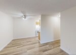 Located at 35 Homestead Crescent in Edmonton, Alberta, this 1-bedroom, 2-bathroom unit offers a practical and comfortable layout across a single floor. Light wood-style flooring runs throughout the space, lending a clean and cohesive look to every room.

The kitchen is a galley-style design featuring warm oak cabinetry, dark laminate countertops, a stainless steel sink, and white appliances including a stove and refrigerator. A dedicated pantry closet provides additional storage. The kitchen flows seamlessly toward the dining area, which is illuminated by a ceiling fan fixture.

The living room is an open, airy space highlighted by a large sliding window and door that lead to a private balcony overlooking mature trees, allowing natural light to fill the room. Baseboard heating is present throughout.

The primary bedroom offers a comfortable footprint with a sliding-door closet, a textured ceiling, and a window for natural light. It connects conveniently to one of the two bathrooms, which features a wide vanity with oak cabinetry, a granite-style countertop, a large mirror with globe lighting, and a shower-tub combo with white tile surround. A second bathroom provides additional convenience. Four closets throughout the unit offer generous storage solutions for everyday living.