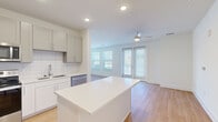 Located at 4939 Ohear Ave in North Charleston, SC, this well-appointed 2-bedroom, 3-bathroom single-story home offers a clean, modern design with a bright, open layout. Light wood flooring runs throughout the entire space, creating a cohesive and airy feel from room to room.

The kitchen serves as a central hub, featuring gray shaker-style cabinetry, a white subway tile backsplash, quartz countertops, a central island, and a full suite of stainless steel appliances including a refrigerator with ice maker, range, microwave, and dishwasher. The kitchen flows seamlessly into the living room, which is bathed in natural light from multiple windows and a glass door, and is outfitted with a ceiling fan.

Both bedrooms are generously proportioned, each with ceiling fans, large windows with blinds that invite natural light, and direct access to closets. The primary bedroom includes a private entry door. Three full bathrooms are finished consistently with white vanities, quartz countertops, tub-shower combinations with white tile surrounds, and light wood-style flooring. Two dedicated closets provide ample storage. The home's clean, neutral palette and modern finishes make for a bright, functional, and comfortable living environment.