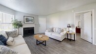Located at 1919 W Tarrant Rd in Grand Prairie, TX, this single-floor, 2-bedroom, 2-bathroom home offers a thoughtfully designed layout with modern finishes throughout. The living room serves as a welcoming centerpiece, featuring wood-style flooring, a textured ceiling, a ceiling fan, and a classic fireplace with a white mantle — ideal for relaxed gatherings. Natural light flows in through the windows, enhancing the home's bright, neutral color palette.

The kitchen is a standout feature, showcasing slate-gray shaker cabinetry, granite countertops, a mosaic tile backsplash, and a full suite of stainless steel appliances. A peninsula with pendant lighting and an adjacent dining area creates a seamless, open-concept flow.

The primary bedroom is a comfortable retreat with a ceiling fan, a natural light-filled window, and access to a spacious walk-in closet with built-in shelving. The second bedroom is equally well-sized with its own closet and ceiling fan. Both bathrooms are finished with gray vanity cabinetry and granite countertops; one features a full tub-shower combination. Wood-style flooring runs consistently throughout the home, tying the design together cohesively.