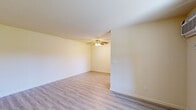 Located in Livermore, CA, this well-appointed one-bedroom, one-bathroom unit offers a thoughtfully organized single-floor layout that makes efficient use of every square foot. Light-toned luxury vinyl plank flooring runs throughout, lending a clean, cohesive look to the entire space.

The living room is a comfortable, open area with neutral cream-toned walls, a ceiling fan with light fixture, and windows that bring in generous natural light and views of the surrounding greenery. The entry area opens directly into the main living space, featuring additional windows and a wall-mounted air conditioning unit for year-round comfort.

The kitchen is cleanly designed with white cabinetry, light countertops, a stainless steel undermount sink positioned beneath a large window overlooking the outdoors, and dark appliances including an electric range. The open sightlines between the kitchen and living area give the space an airy, connected feel.

The bedroom is a well-sized, sunlit room with large windows that allow natural light to pour in. Ample wall space provides flexibility for furniture arrangement, and a closet offers dedicated storage.

The bathroom is neatly finished with a full tub and shower combo enclosed by sliding glass doors and marble-patterned surrounds, a white vanity with sink, and matching light flooring that ties the room together cohesively.