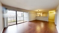This 880 square foot single-story home in Covington, Kentucky offers a well-designed living space with two bedrooms and two bathrooms. The property features a modern kitchen with white cabinetry, subway tile backsplash, and stainless steel appliances, including a built-in microwave and dishwasher. The living area boasts rich hardwood flooring and a large sliding glass door, providing ample natural light and access to outdoor space.

Both bedrooms are carpeted and offer good-sized closet space. The primary bedroom measures 140 square feet, providing a comfortable retreat. The bathrooms are clean and functional, featuring white tile surrounds and modern fixtures. One bathroom includes a shower/tub combination, while the other offers a standing shower.

The home's layout is efficient, with two hallways providing easy access to all rooms. The open concept design of the kitchen and living area creates a sense of spaciousness, ideal for entertaining or everyday living. Throughout the home, neutral wall colors and simple, clean lines contribute to a contemporary aesthetic. The property's compact size and thoughtful design make it an excellent option for those seeking a low-maintenance yet comfortable living space.