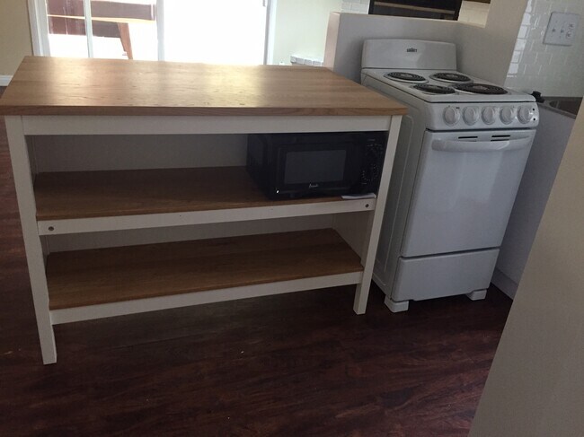 Kitchen island with microwave - 6522 Camino Caseta