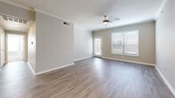 Located at 1420 West McDermott Drive in Allen, TX, this single-story, three-bedroom, two-bathroom home offers a well-organized and functional layout. The open-concept living room is bright and welcoming, featuring wood-look laminate flooring, crown molding, a ceiling fan, and large windows that allow natural light to fill the space. A glass door provides additional light and exterior access.

The kitchen is efficiently designed with ample white cabinetry, light countertops, and a full suite of stainless steel appliances including a refrigerator, electric range, built-in microwave, and dishwasher. Wood-look flooring continues seamlessly from the living area into the kitchen.

The spacious primary bedroom features plush carpet, a ceiling fan, a walk-in closet, and a dedicated en-suite bathroom. The additional bedrooms are carpeted, each served by a ceiling fan, and one includes a closet and a window with outdoor views. Both bathrooms are consistent in design, showcasing wood-look flooring, white cabinetry, and tiled tub-shower combinations with a distinctive gold diamond tile accent border. Two hallways and additional closets provide practical storage throughout. The overall aesthetic is clean, neutral, and move-in ready.