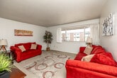 Located at 900 W Benton St in Iowa City, Iowa, this single-floor unit offers five bedrooms and one bathroom within a compact, efficiently arranged floor plan. The living room provides a welcoming common area with neutral-toned carpet, a textured ceiling, and a large window that brings in natural light and views of the surrounding neighborhood. The space flows naturally into the combined kitchen and dining area, which features warm oak cabinetry, ample upper and lower storage, light tile flooring, a coil-burner electric range, dishwasher, and a full-size refrigerator — offering a practical and well-equipped cooking space. The five bedrooms are carpeted and offer a quiet, comfortable retreat, each with closet storage including bi-fold or sliding-door closets with built-in hanging rods. The primary bedroom is a comfortable size with a window for natural light. The shared full bathroom includes a tub/shower combination with tile flooring, keeping things clean and functional. A hallway connects the bedrooms and shared spaces, contributing to a logical and easy-to-navigate layout. Overall, this unit offers a straightforward, practical living environment well-suited for shared occupancy in a residential Iowa City setting.