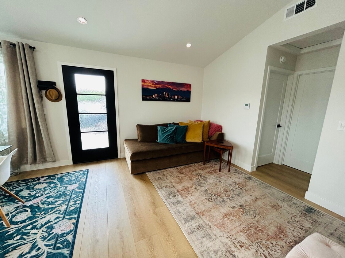 Espacio de entrada y sala de estar con muebles de West Elm - 4415 Catalpa St