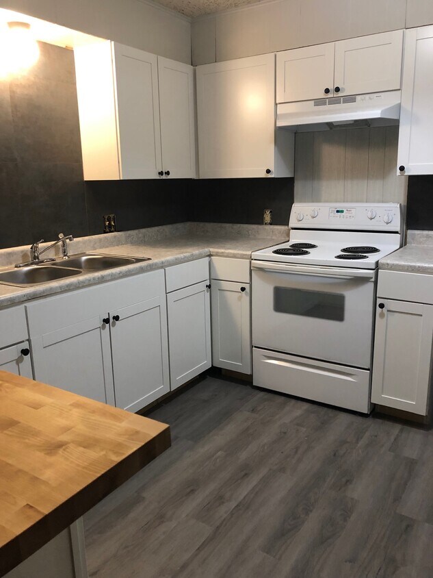 Newly updated kitchen, brand new cabinets and flooring. - 210 27th St NE