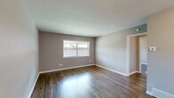 Located at 4015 Summer Ave in Memphis, Tennessee, this single-floor 2-bedroom, 1-bathroom unit offers a clean, modernized interior with a cohesive neutral color palette throughout. The open-concept kitchen and living area serve as the heart of the home, where light vinyl flooring, white shaker-style cabinetry, marble-look countertops, and a peninsula with decorative paneling create a bright and functional space. A double sink and a dishwasher complete the kitchen's practical layout, while the adjacent living area features a paneled entry door and a window that draws in natural light.

Both bedrooms are finished with rich, dark hardwood-style flooring and warm gray walls, offering a comfortable and grounded atmosphere. Each room includes windows with exterior views, providing natural light and ventilation. The primary bedroom is generously sized and includes a closet and direct access to the hallway. A second bedroom offers similar finishes and a window overlooking greenery.

The bathroom is a standout feature, clad in classic white subway tile from floor to ceiling in the tub surround, with a window that adds natural light and a fresh, airy feel. A connecting hallway ties all rooms together efficiently, completing this well-designed and move-in-ready unit.