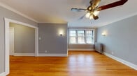 Located at 238 Washington Blvd in the historic village of Oak Park, Illinois, this single-floor unit showcases a blend of classic architectural character and functional design. Rich hardwood floors run throughout the space, reflecting natural light and lending warmth to every room.

The living area is generously proportioned, painted in a soft gray palette, and highlighted by elegant crown molding, a ceiling fan with integrated lighting, and wall sconces that add a refined ambiance. A wide, multi-pane window allows natural light to pour in, while a cast-iron radiator underscores the building's timeless construction.

The bedrooms follow a consistent design language, each featuring hardwood floors, ceiling fans, gray walls with crisp white trim, and individual windows that frame views of the surrounding greenery. Cast-iron radiators are present throughout, providing a nod to the building's heritage.

The kitchen is equipped with white shaker-style cabinetry, granite-look countertops, a stainless steel sink, and a stainless steel dishwasher, offering both practicality and clean aesthetics.

The bathroom presents a classic design with white subway tile surrounding a full bathtub and shower, complemented by a dark-framed vanity mirror and a window providing natural ventilation. The overall atmosphere is clean, bright, and thoughtfully maintained.