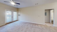Located at 8816 Aspinwall Dr in Charlotte, NC, this single-floor, 2-bedroom, 2-bathroom home offers a well-designed layout with a seamless flow between living spaces. The open-concept kitchen serves as the heart of the home, showcasing dark espresso cabinetry, granite countertops, black appliances including a range, microwave, and refrigerator, and a central island with a built-in sink and pendant lighting overhead. Rich hardwood-style flooring runs through the kitchen and bathrooms, while plush carpeting covers the living area and bedrooms, creating a warm and comfortable atmosphere.

The spacious living area features a ceiling fan and a glass door that invites natural light. Both bedrooms are carpeted and well-lit, each equipped with ceiling fans and windows offering outdoor views. The primary bedroom is generously sized with a large window and closet access. The second bedroom also includes a closet and connects easily to the hallway.

Both bathrooms are finished with granite-topped dark vanities, hardwood-style flooring, and full tub-shower combinations with brushed nickel fixtures, providing a clean and cohesive aesthetic. A connecting hallway links the bedrooms and bathrooms efficiently. The overall design is neutral, modern, and functional, making this Charlotte home a comfortable and practical living space.