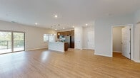 Located at 915 Main St in Mukwonago, Wisconsin, this single-floor unit offers a clean, modern design with an open-concept layout that seamlessly connects the living and kitchen areas. Light-toned luxury vinyl plank flooring runs throughout the main living spaces, creating a bright and cohesive feel.

The kitchen is a standout feature, highlighted by rich dark-stained cabinetry extending to the ceiling for ample storage, granite countertops, and a full suite of stainless steel appliances including a refrigerator, range, microwave, and dishwasher. A central island with matching granite provides additional prep space and is illuminated by stylish pendant lighting. A window above the kitchen area allows natural light to pour in, offering views of the surrounding greenery.

The open living area is generously proportioned, bathed in natural light, and provides a versatile canvas for a variety of layouts. Recessed lighting throughout enhances the clean, contemporary aesthetic.

The bathroom features rich wood cabinetry, granite countertops, a large wall mirror, and marble-style tile flooring, complemented by a full tub-shower combination. Bedrooms include plush carpeting and windows that bring in natural light. A dedicated laundry room houses a full-size front-load washer and dryer, adding everyday convenience to this well-appointed home.