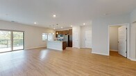 Located at 915 Main St in Mukwonago, Wisconsin, this single-floor unit offers a clean, modern design with an open-concept layout that seamlessly connects the living and kitchen areas. Light-toned luxury vinyl plank flooring runs throughout the main living spaces, creating a bright and cohesive feel.

The kitchen is a standout feature, highlighted by rich dark-stained cabinetry extending to the ceiling for ample storage, granite countertops, and a full suite of stainless steel appliances including a refrigerator, range, microwave, and dishwasher. A central island with matching granite provides additional prep space and is illuminated by stylish pendant lighting. A window above the kitchen area allows natural light to pour in, offering views of the surrounding greenery.

The open living area is generously proportioned, bathed in natural light, and provides a versatile canvas for a variety of layouts. Recessed lighting throughout enhances the clean, contemporary aesthetic.

The bathroom features rich wood cabinetry, granite countertops, a large wall mirror, and marble-style tile flooring, complemented by a full tub-shower combination. Bedrooms include plush carpeting and windows that bring in natural light. A dedicated laundry room houses a full-size front-load washer and dryer, adding everyday convenience to this well-appointed home.