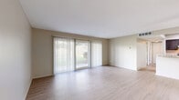 Located at 6500 Maplewood Rd in Mayfield Heights, Ohio, this 2-bedroom, 1-bathroom residence offers a thoughtfully designed single-floor layout with a clean, neutral palette throughout. The open living room is a standout feature, showcasing light wood-style luxury vinyl flooring, warm beige walls, and a large sliding glass door with vertical blinds that floods the space with natural light. The kitchen is well-equipped with dark gray shaker-style cabinetry, marble-patterned countertops, and a full suite of stainless steel appliances including a gas range, dishwasher, and refrigerator — all set atop matching light wood-style flooring. Both bedrooms feature plush wall-to-wall carpeting and ceiling fans, with ample natural light provided by windows dressed with horizontal blinds. The primary bedroom is generously sized and includes a dedicated closet with bifold doors, while the second bedroom offers a comfortable, cozy feel with its own closet access. The bathroom is clean and functional, featuring a full soaking tub with white tile surround. Throughout the residence, neutral tones, practical finishes, and a well-connected layout create a comfortable and move-in-ready living environment.