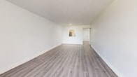 Located at 2725 Somerset Dr in Lauderdale Lakes, Florida, this 1-bedroom, 2-bathroom residence offers a clean, modern aesthetic throughout its thoughtfully laid-out single floor. Durable wood-look plank flooring runs continuously through the space, lending a cohesive and contemporary feel.

The entrance opens into a hallway with convenient closet storage, leading to the expansive combined living and dining area. This open room is bathed in natural light from a large sliding glass door that opens directly onto a private balcony with outdoor views, creating a seamless indoor-outdoor connection. A pass-through window connects the living area to the kitchen, which features white shaker-style cabinetry with dark hardware, light countertops, and stainless steel appliances. A window in the kitchen frames lush tropical greenery outside.

The generously sized primary bedroom is bright and airy, with a large window overlooking the surrounding neighborhood and ample closet space provided by louvered bifold doors. Three closets total are distributed throughout the unit, offering excellent storage.

Both bathrooms are finished in a crisp, contemporary style. One features marble-look tile surrounding a full soaking tub and shower combination, while the second includes a white vanity with clean fixtures and matte black hardware accents. The overall ambiance is light, fresh, and move-in ready.