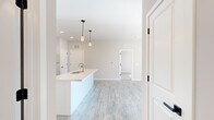 Located at 226 Bucknoll Road in Manheim, PA, this thoughtfully designed 2-bedroom, 2-bathroom residence offers comfortable single-floor living across a generously sized floor plan. The open-concept layout seamlessly connects the kitchen, dining, and living areas, creating an inviting and functional space throughout.

The modern kitchen is a standout feature, showcasing crisp white shaker cabinetry with matte black hardware, stainless steel appliances including a range, microwave, and refrigerator, and a large central island with a built-in sink and pendant lighting above. Light wood-tone luxury vinyl plank flooring runs throughout the main living areas, adding warmth and continuity.

The living room is bright and airy, benefiting from natural light that pours in through sliding glass doors leading to a private balcony with open views of the surrounding community and green space. The two bedrooms are carpeted for comfort, with the primary bedroom offering a well-proportioned layout and direct access to its own bathroom. The second bathroom features a full tub-shower combination with clean, neutral finishes and wood-tone flooring. A dedicated entrance and ample interior hallway space complete the floor plan. The overall aesthetic is clean, contemporary, and move-in ready.