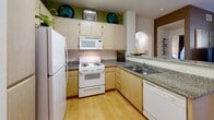 This well-appointed 3-bedroom, 2-bathroom home in Dublin, CA offers a thoughtfully designed single-floor layout. The open-concept kitchen and living area serves as the heart of the home, featuring light maple cabinetry, granite countertops, a gas range, and a breakfast bar with bar seating — all illuminated by a skylight overhead. Hardwood-style flooring runs through the kitchen, transitioning to plush carpet in the living and bedroom areas. The living room is bright and welcoming, with sliding glass doors that open to a private patio, bringing in natural light and outdoor views. The spacious primary bedroom features large windows overlooking greenery, an accent wall, and generous closet space. A second walk-in closet provides additional storage throughout. Two full bathrooms serve the home, each featuring a tub-shower combination. The secondary bathroom includes a long vanity with ample cabinetry. Three hallways connect the rooms efficiently, contributing to a smooth and functional floor plan. Arched doorways add a subtle architectural charm to the interior. The overall ambiance is warm and residential, with a layout that balances comfort and practicality in a compact yet efficiently utilized footprint.