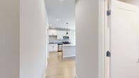 Located at 5033 Old Middleton Rd in Madison, WI, this well-appointed one-bedroom, one-bathroom unit offers a thoughtfully designed single-floor layout with modern finishes throughout. The kitchen serves as a central highlight, featuring white shaker cabinetry, granite countertops, stainless steel appliances, and a central island with pendant lighting overhead. Light hardwood flooring flows through the main living and kitchen areas, lending a warm, cohesive feel. Sliding glass doors open to a private balcony that overlooks lush tree-lined streets and neighboring brick buildings, offering a pleasant outdoor retreat with open sky views. The bedroom is a comfortable, well-proportioned space with soft carpeting, a ceiling fan, a large window that fills the room with natural light, and a double-door closet providing ample storage. The bathroom is finished with a granite-topped vanity, tile-like hardwood flooring, a large mirror, and clean, neutral walls that create a calm and functional space. Neutral tones and recessed lighting are used consistently throughout, contributing to a bright, modern ambiance. The unit is ideally situated in a residential Madison neighborhood with convenient access to local amenities.