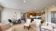 This well-appointed one-bedroom, two-bathroom residence at 584 Stone Table Blvd in Plainfield, Indiana offers a thoughtfully designed single-floor layout. The open-concept living and dining area is anchored by light hardwood-style flooring, recessed lighting, and large windows that invite generous natural light throughout. A cozy seating arrangement and dining space flow seamlessly into the kitchen, which features warm wood cabinetry, granite-style countertops, a subway tile backsplash, stainless steel appliances, and a central island with a dark countertop — ideal for both cooking and casual dining. The primary bedroom is a comfortable retreat with plush carpeting, a broad window with room-darkening blinds, and a ceiling fan. A spacious walk-in closet with built-in shelving and hanging rods provides ample storage. The dedicated office offers carpeted floors, a window for natural light, and enough room for a full workspace. Both bathrooms are finished with gray cabinetry, granite-topped vanities, and light wood-style tile flooring — one featuring a tub-shower combination. A connecting hallway ties all rooms together, giving the home a cohesive and functional flow throughout.