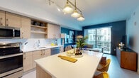 Located at 1100 NW North River Dr in Miami, FL, this thoughtfully designed single-floor residence blends modern aesthetics with functional living. The open-concept kitchen is a standout feature, outfitted with light wood cabinetry, stainless steel appliances, a herringbone-patterned tile backsplash, and a generous white quartz island with pendant lighting overhead — ideal for both cooking and entertaining. The kitchen flows seamlessly into the living area, which is distinguished by bold teal accent walls, a woven pendant light, and a large sliding glass door that opens to a private balcony, allowing abundant natural light to fill the space. The bedroom offers a serene retreat with sliding glass door access to outdoor views, soft neutral tones, and ample storage. A second bedroom provides a clean, versatile layout with its own balcony access. The bathroom features white quartz countertops, a undermount sink, and a glass-enclosed walk-in shower with marble-style tile surround. Throughout the residence, light tile flooring, smart home controls, and a dedicated laundry area add practical convenience. The overall ambiance is fresh, contemporary, and unmistakably Miami-inspired.
