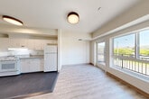 Located at 2905 Santa Rosa Ave in Santa Rosa, CA, this thoughtfully laid-out one-bedroom, one-bathroom unit offers a comfortable and efficient living environment across a single floor. The open-concept living, dining, and kitchen area forms the heart of the unit, with light wood-style flooring flowing through the space and flush-mount ceiling fixtures providing warm, even lighting. Large windows and a glass-panel balcony door invite abundant natural light and frame pleasant outdoor views, extending the feel of the interior. The balcony offers a pleasant outdoor retreat with views of the surrounding neighborhood and rolling hills. The kitchen is well-appointed with white cabinetry offering ample storage, a full-size refrigerator, a white range, a dishwasher, and a double sink with laminate countertops set against durable dark flooring. The bedroom is a calm, carpeted retreat featuring a mirrored sliding-door closet, a large window with scenic hill views, and soft neutral tones throughout. Additional closet spaces provide generous storage options. The bathroom is clean and functional, complete with a tub-shower combination, a wall-mounted sink, a mirrored medicine cabinet, and light wood-style flooring. The unit's bright, neutral palette and practical design make it an inviting and efficient living space.
